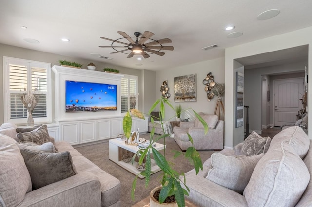 living room with ceiling fan and carpet flooring