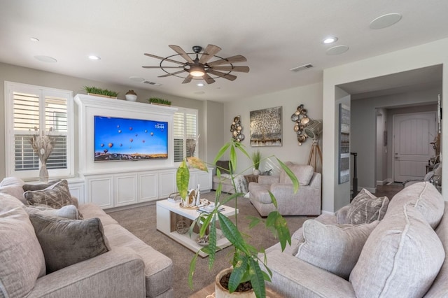 carpeted living room featuring visible vents, a ceiling fan, and recessed lighting