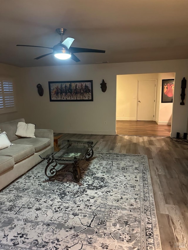 living room featuring hardwood / wood-style flooring and ceiling fan