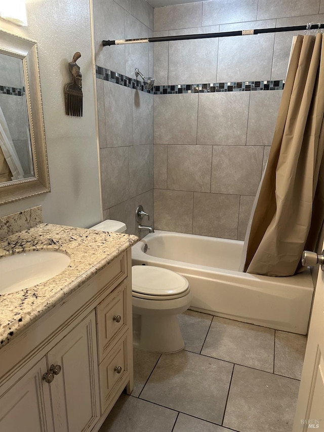 full bathroom featuring tile patterned floors, vanity, toilet, and shower / tub combo