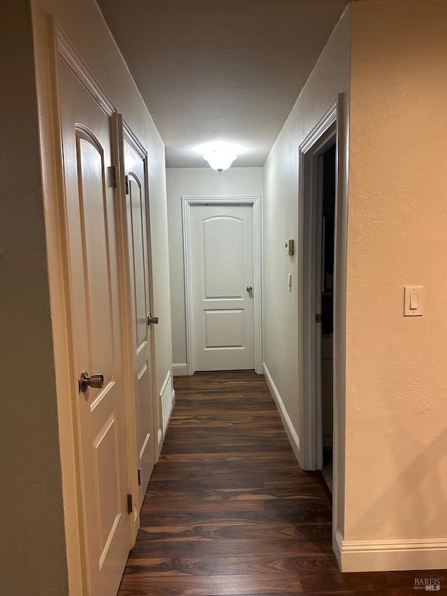 hallway featuring dark hardwood / wood-style flooring