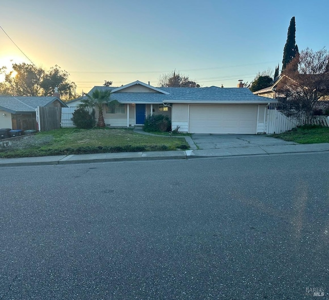 view of front of property featuring a garage and a yard