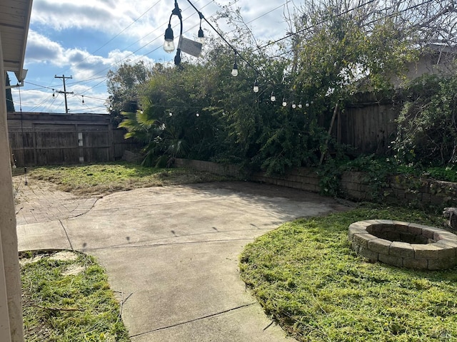 view of yard featuring a patio and a fire pit