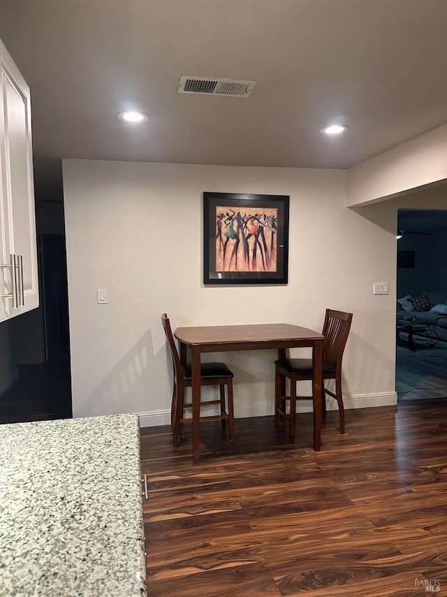 dining area with dark hardwood / wood-style flooring