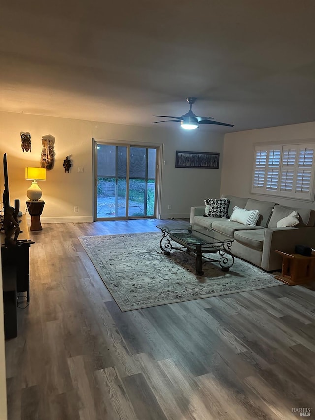 living room with ceiling fan, hardwood / wood-style flooring, and a healthy amount of sunlight