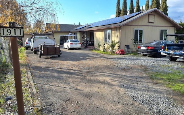 single story home featuring solar panels