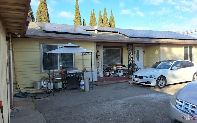 view of front of home with a gazebo and solar panels