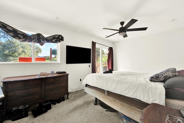 carpeted bedroom featuring access to exterior and ceiling fan