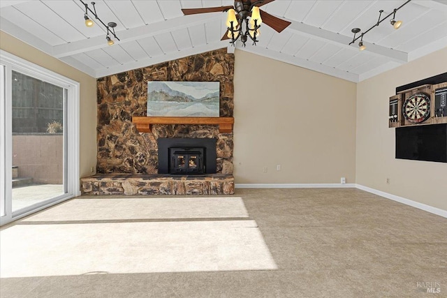 unfurnished living room featuring vaulted ceiling with beams, carpet, wood ceiling, ceiling fan, and track lighting