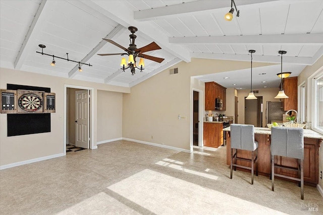 living room with vaulted ceiling with beams, track lighting, sink, and ceiling fan