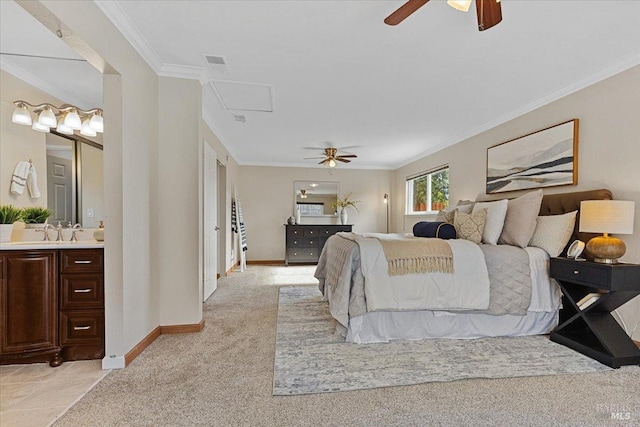 carpeted bedroom featuring sink, crown molding, ensuite bath, and ceiling fan