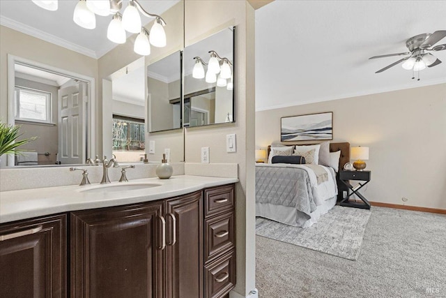 bathroom featuring ceiling fan, ornamental molding, and vanity