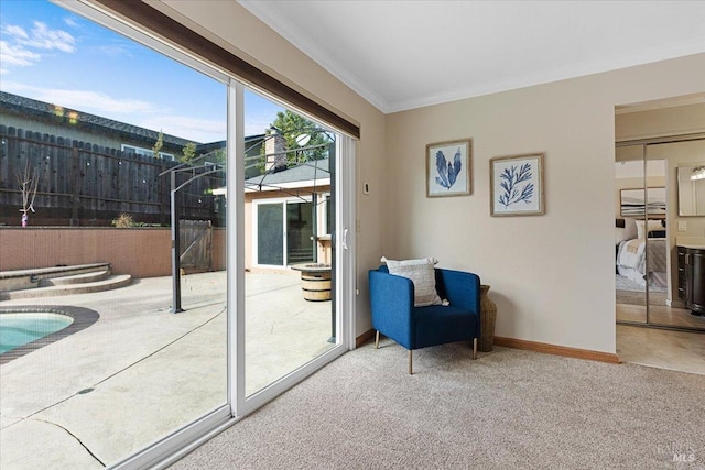 doorway to outside featuring ornamental molding and carpet floors