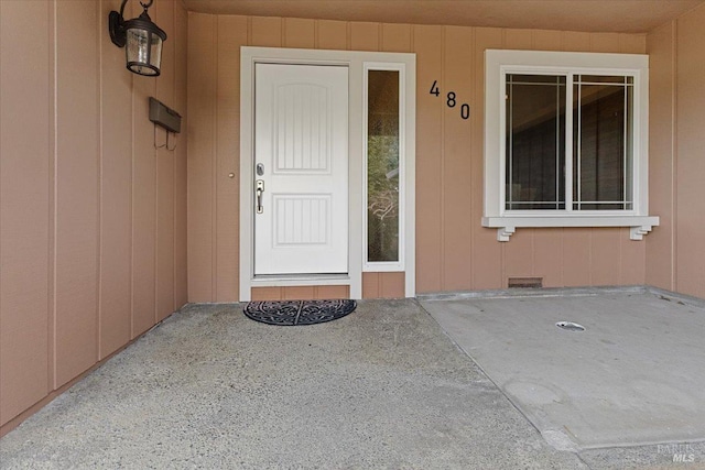 view of exterior entry featuring crawl space and visible vents