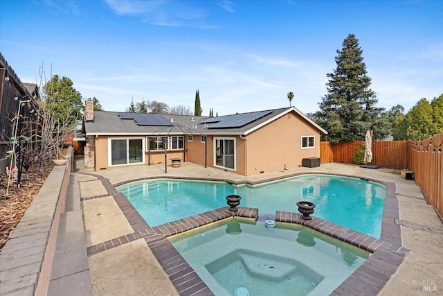 view of swimming pool featuring an in ground hot tub and a patio