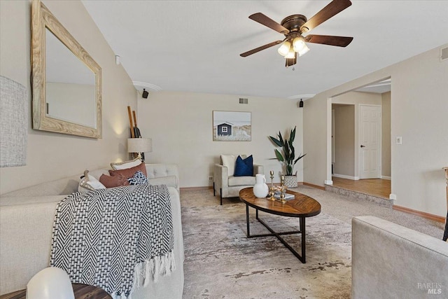 living room with ceiling fan and carpet flooring