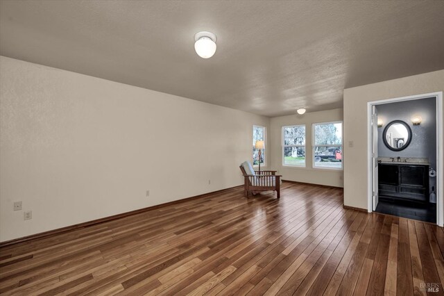 interior space with sink, hardwood / wood-style flooring, and a textured ceiling