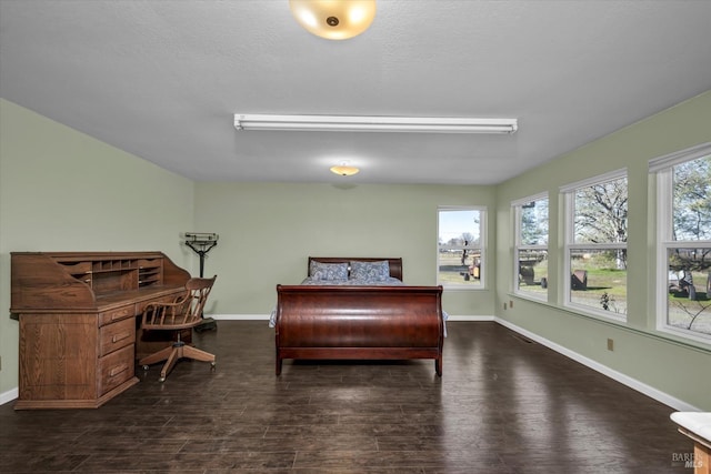 bedroom featuring dark wood-type flooring and a textured ceiling