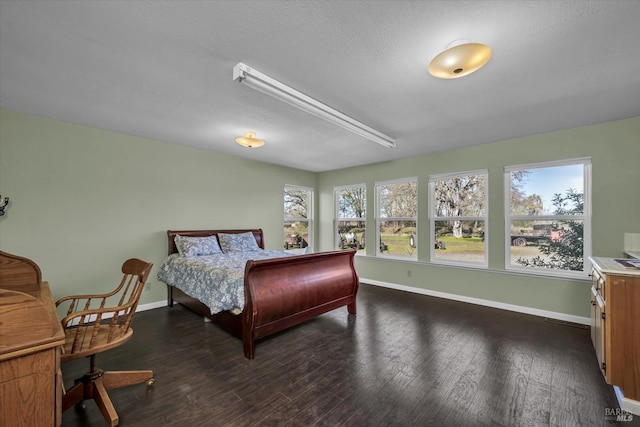 bedroom with dark wood-type flooring and a textured ceiling