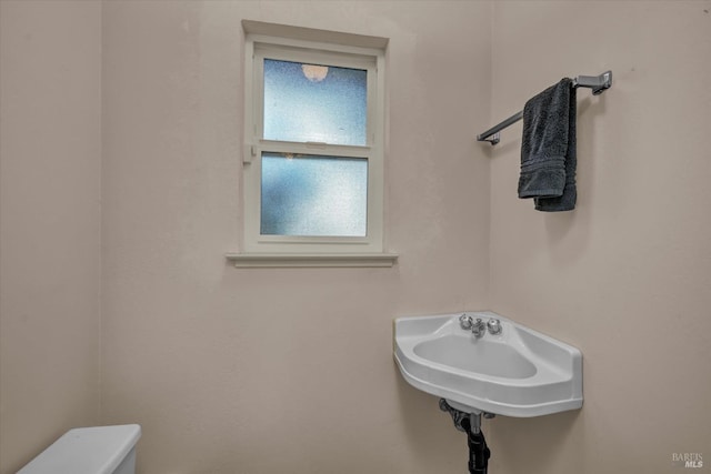 bathroom featuring sink and toilet