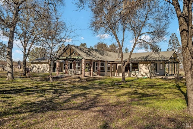 back of property with a yard and a patio area