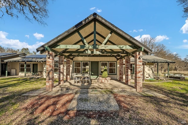 back of property with a patio and a lawn