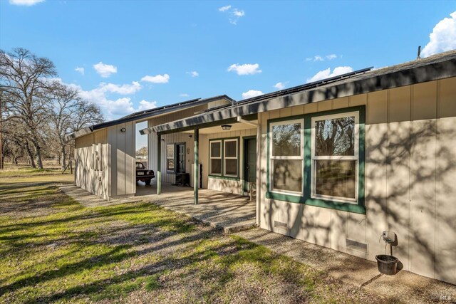 rear view of house with a lawn and a patio area