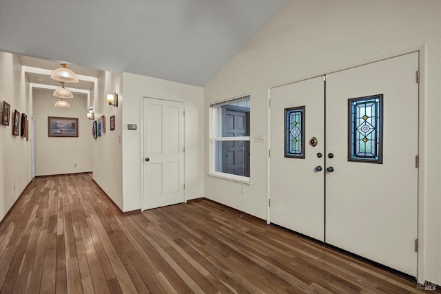 foyer featuring dark hardwood / wood-style flooring and lofted ceiling