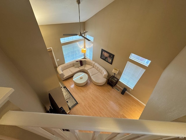 living room with a towering ceiling and hardwood / wood-style floors