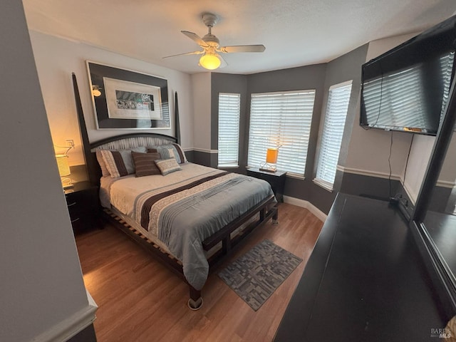 bedroom featuring hardwood / wood-style flooring and ceiling fan