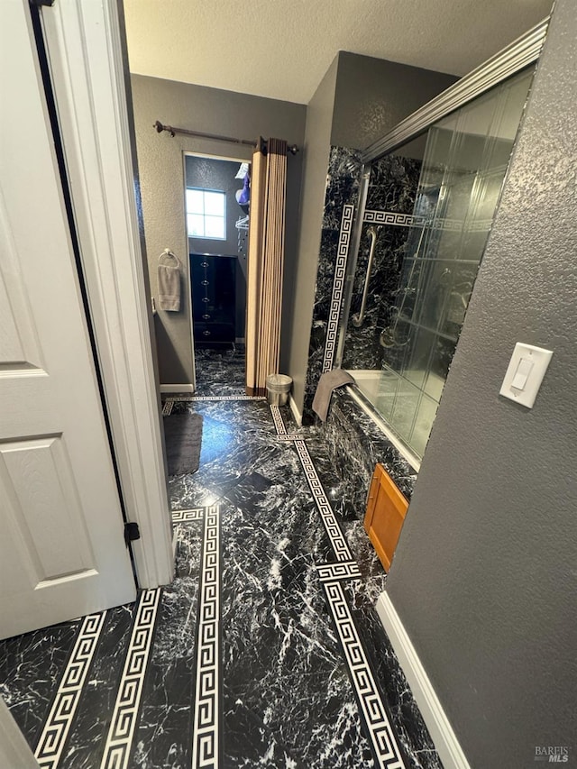 hallway with a textured ceiling