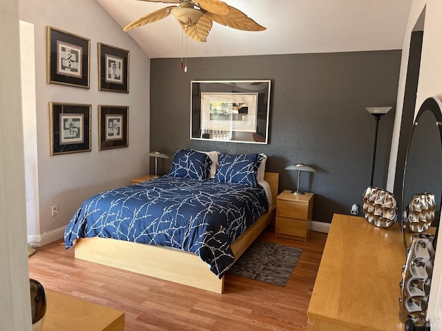 bedroom with hardwood / wood-style flooring and vaulted ceiling