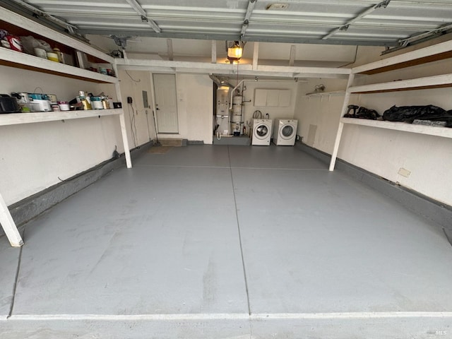 garage with a garage door opener and washer and dryer