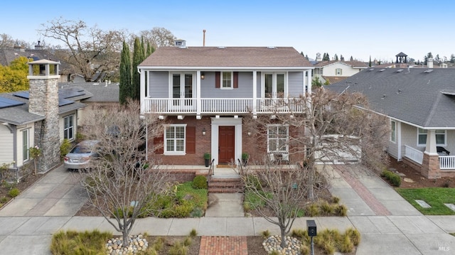 view of front of property featuring a balcony