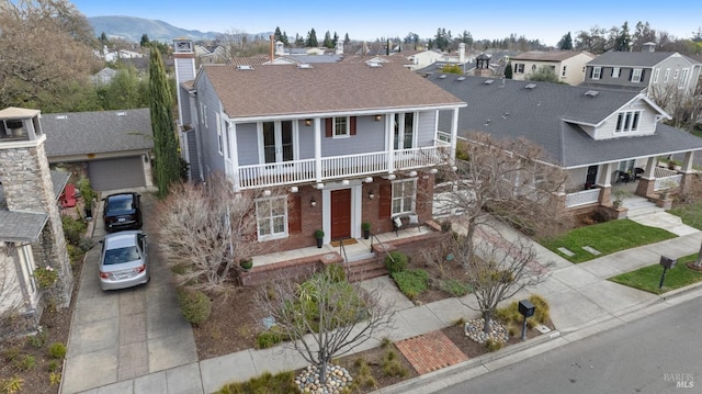 view of front of home with a balcony and a mountain view