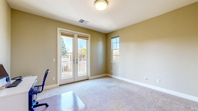 home office with french doors and light colored carpet