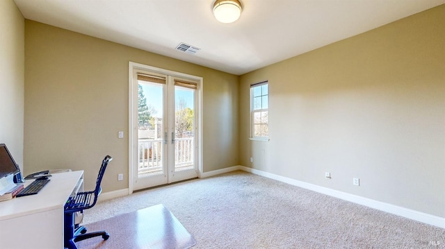 office featuring french doors, light carpet, visible vents, and baseboards