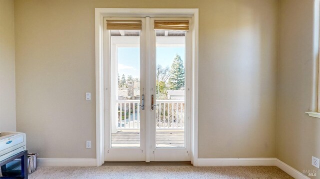 doorway to outside with light colored carpet