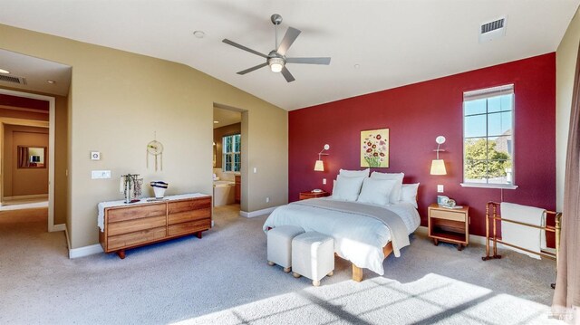 carpeted bedroom featuring lofted ceiling, ceiling fan, and ensuite bathroom