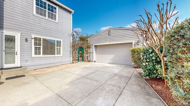 view of side of property featuring a garage and an outdoor structure