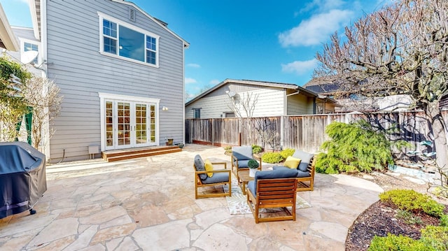 view of patio with a fenced backyard, an outdoor hangout area, grilling area, and french doors