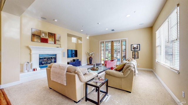 carpeted living room featuring french doors and a healthy amount of sunlight