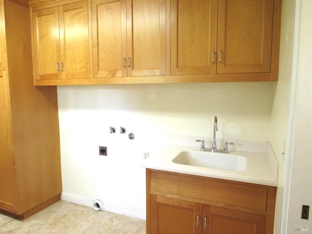 laundry room with electric dryer hookup, sink, hookup for a washing machine, and cabinets