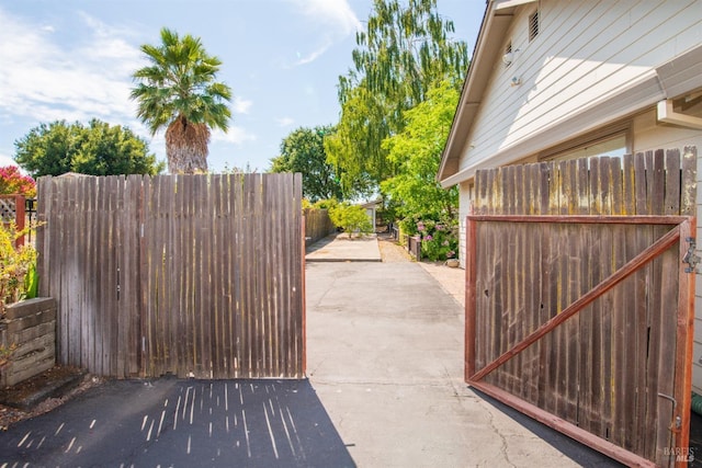 view of gate featuring a patio area