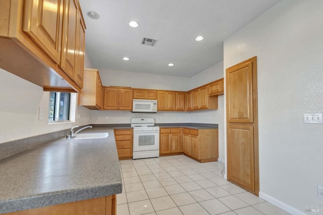 kitchen with sink, white appliances, and light tile patterned flooring