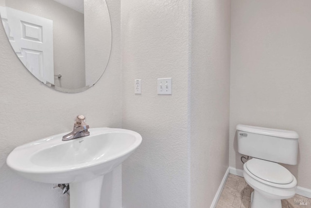 bathroom featuring sink and toilet