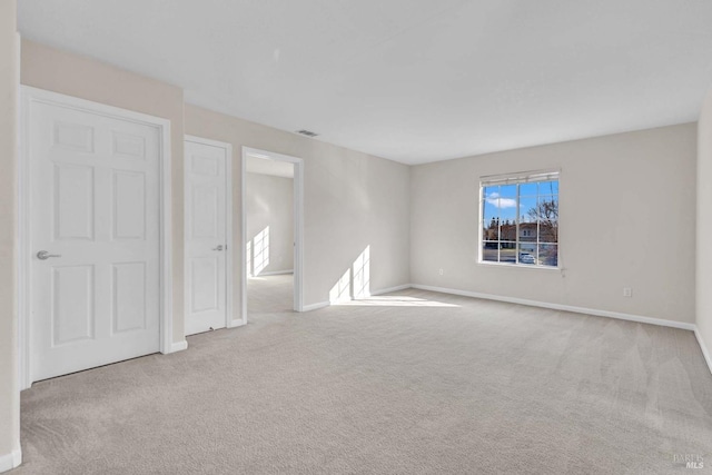 unfurnished room with light carpet