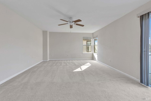 empty room with ceiling fan and light colored carpet