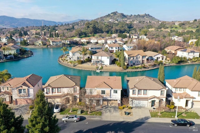 aerial view featuring a water and mountain view