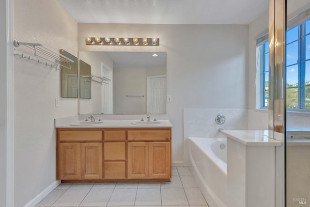 bathroom featuring a tub to relax in, tile patterned flooring, and vanity